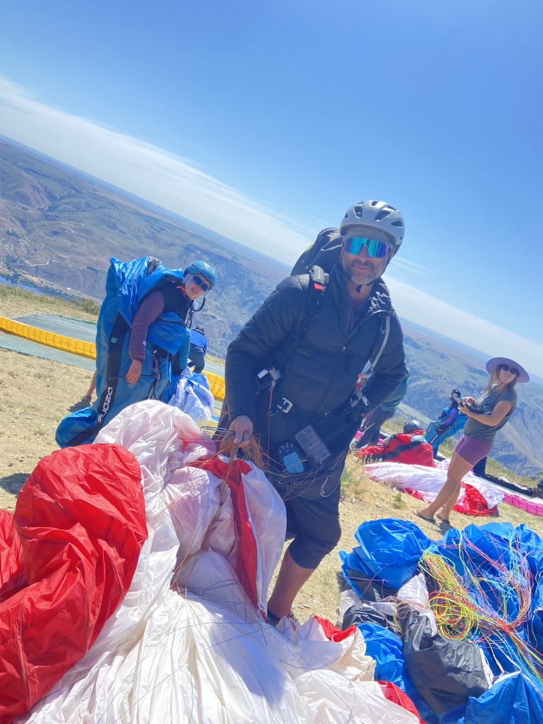 Pilots preparing paragliders on top of mountain, Chelan