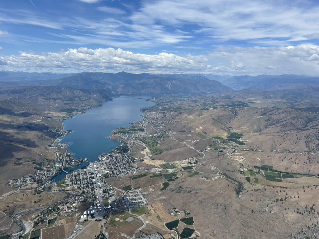 Aerial panoramic view of Lake Chelan and surrounding hills.